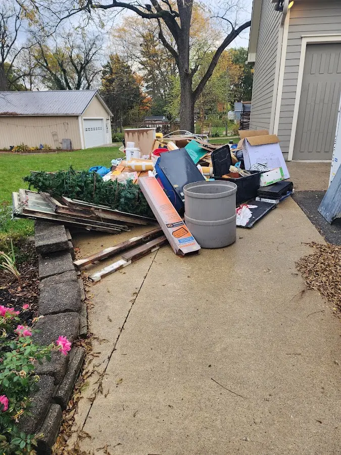 Dumpster being loaded with debris for 12 Yard Dumpster Rental in Three Rivers